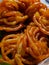 Jalebi is a popular Indian sweet snack in pretzel or circular shapes