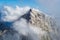 Jalovec ridge in the Julian Alps, Triglav National Park, Slovenia, with misty clouds and blue sky. Climbing, mountaineering.