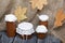 Jam in glass jars. Nearby are dried maple leaves. On a background of coarse linen fabric