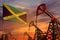 Jamaica oil industry concept. Industrial illustration - Jamaica flag and oil wells with the red and blue sunset or sunrise sky