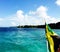 Jamaican Flag trailing boat in the Ocean