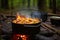 jambalaya bubbling in a pot over crackling open fire