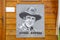 James Arness portrait hanging on wooden wall