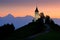 Jamnik church sunrise, landscape in Slovenia, nature in Europe. Foggy Triglav Alps with forest, travel in Slovenia. Beautiful