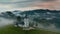 Jamnik, Slovenia - 4K aerial drone footage of flying slowly towards St.Primoz church on a foggy morning