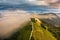 Jamnik, Slovenia - Aerial drone view of a foggy summer sunrise at Jamnik St.Primoz church