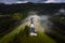 Jamnik, Slovenia - Aerial drone view of a foggy summer sunrise at Jamnik St.Primoz church with fog