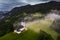 Jamnik, Slovenia - Aerial drone view of a foggy summer sunrise at Jamnik St.Primoz church. The fog gently goes around the chapel