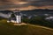 Jamnik, Slovenia - Aerial drone view of a golden sumer sunrise at Jamnik St.Primoz church