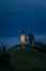 Jamnik, Slovenia - Blue hour at Jamnik with illuminated St. Primoz hilltop church on a foggy dawn with Julian Alps