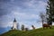 Jamnik, Slovenia - Goats and the beautiful church of St. Primoz in Slovenia