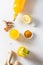 Jamu beverage of turmeric, ginger, lemon on white background. Vertical. View from above