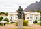 Jan Christiaan Smuts statue. Boldly standing surrounded by colorful greenery.