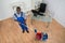 Janitor Cleaning Floor With Wet Floor Sign