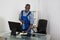 Janitor Cleaning Glass Desk With Cloth In Office