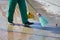 Janitor cleans the sidewalk of the city from fallen leaves