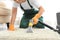 Janitor removing dirt from rug with carpet cleaner indoor