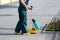 Janitor sweeping broom street