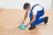 Janitor Sweeping Floor With Brush And Dustpan