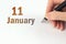 January 11st . Day 11 of month, Calendar date. The hand holds a black pen and writes the calendar date. Winter month, day of the