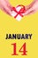 January 14th. Festive Vertical Calendar With Hands Holding White Gift Box With Red Ribbon And Calendar Date