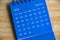 January 2023 blue desk calendar on wooden table background. Calendar concept.