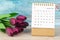 The January 2023 Desk calendar for 2023 year with flower on wooden background