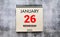 January 26th. 26 January calendar on the wood photo frame with brown brick background