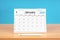 January monthly desk calendar for 2024 year and pen on wooden table