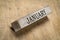 January text on grunge wooden block