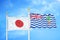 Japan and British Indian Territory two flags on flagpoles and blue cloudy sky