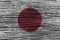 Japan flag with high detail of old wooden background .