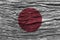 Japan flag with high detail of old wooden background .