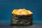 Japan gunkanmaki sushi baked with cheese on blue background