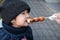 Japan, Kid eating Mitarashi Dango, Traditional Japanese rice dumpling sweet soy glaze. The dumplings are skewered on a bamboo