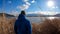 Japan - A man walking in between golden grass at the shore of Kawaguchiko Lake with the view on Mt Fuji