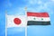Japan and Syria two flags on flagpoles and blue cloudy sky