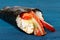 Japan temaki sushi in nori with rice, salmon, cream cheese, bell