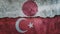 Japan and Turkey flag on cracked wall background. Economics, politics conflicts, war concept texture background