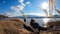 Japan - A woman walking in between golden grass at the shore of Kawaguchiko Lake with the view on Mt Fuji