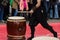 Japanese artist playing on traditional taiko drums