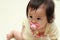 Japanese baby girl sucking on a pacifier