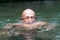 Japanese bald head guy emerging from water