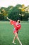 Japanese ballerina dances on lawn background