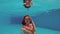 Japanese ballerina is dancing under water in pool.