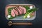 Japanese barbecue wagyu dry aged fillet steak sliced with daikon and leek on a modern design plate