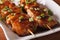 Japanese barbecue: yakitori chicken on a plate close-up. horizon