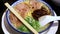 Japanese barbecued char siu pork ramen noodles in pork-bone broth and topped with scallions.