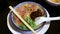 Japanese barbecued char siu pork ramen noodles in pork-bone broth and topped with scallions.