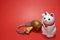 Japanese beckoning cat and lucky mallet close up in the red